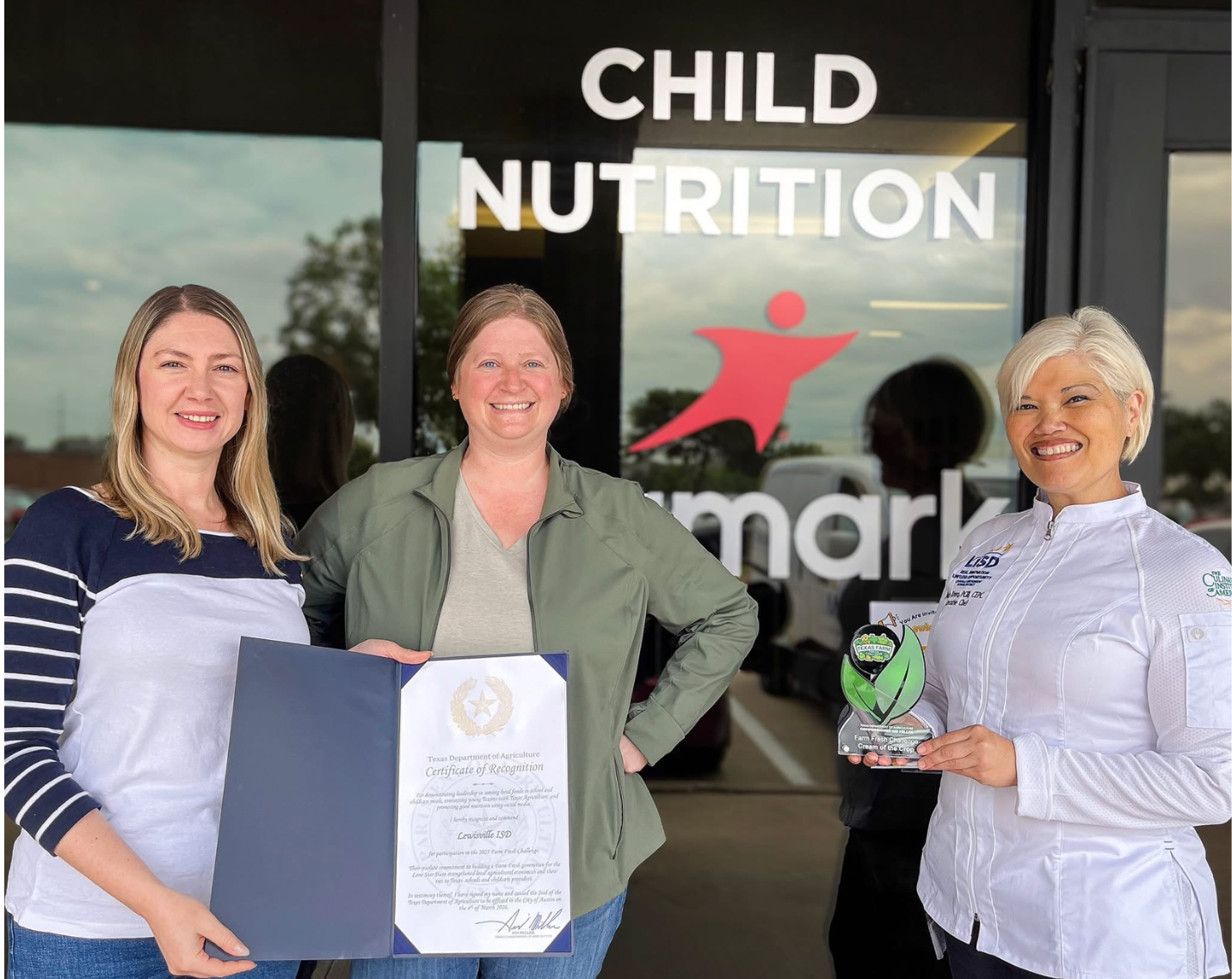 Individuals pose with an award from the Texas Department of Agriculture for their participation in the Farm Fresh Challenge.